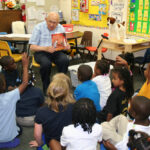 Resident reading to students